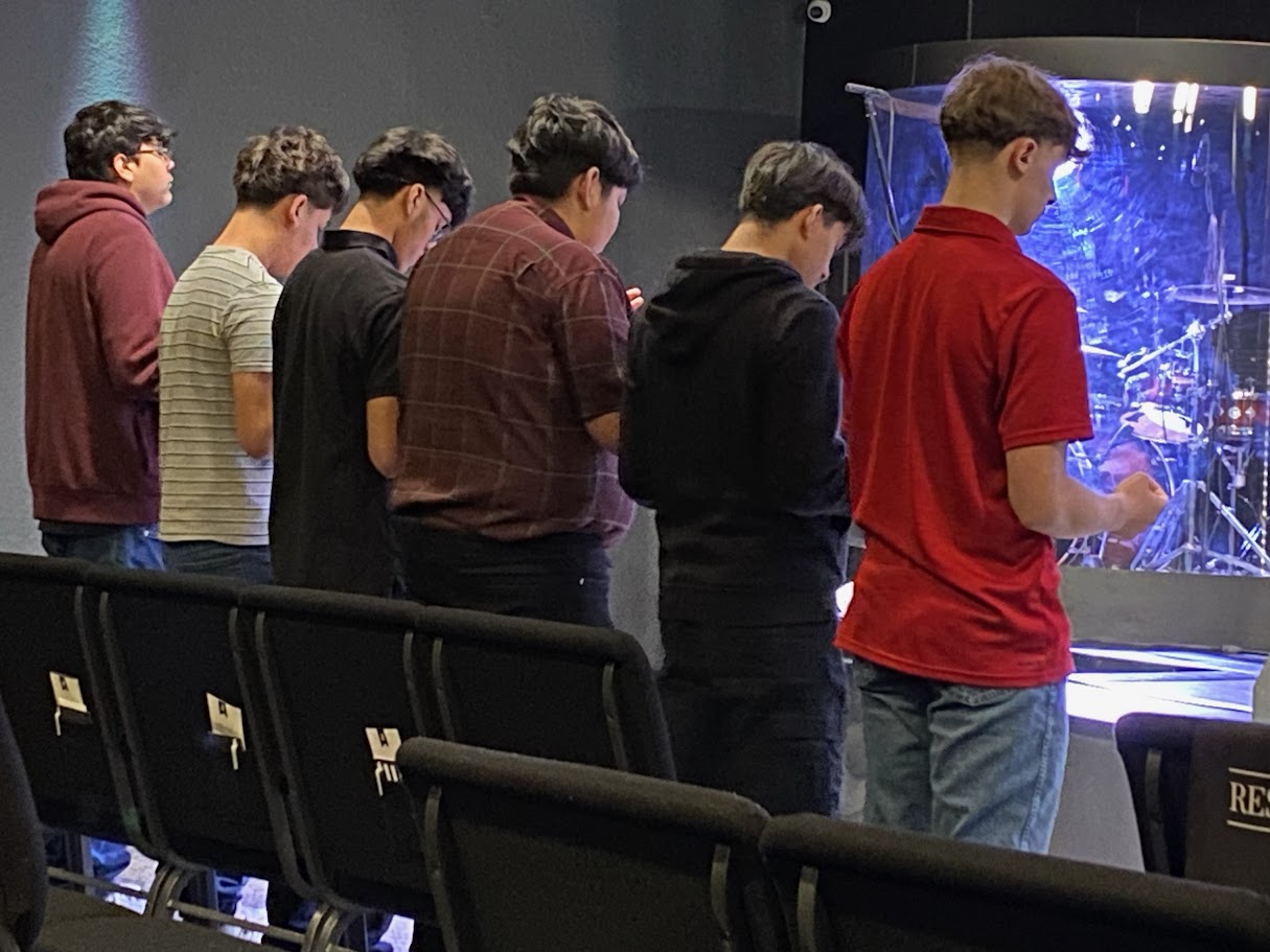 The New Life Hutto church family praying together